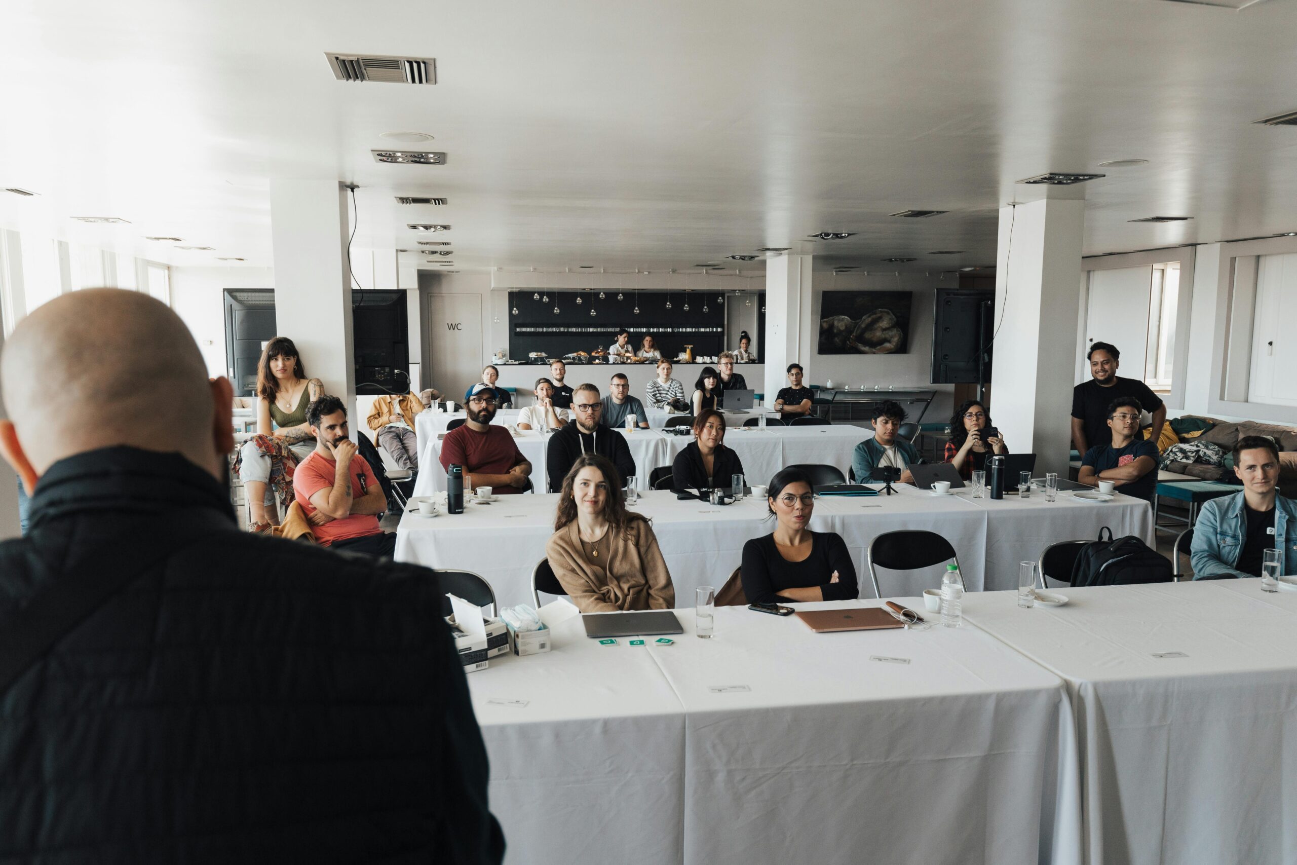 A diverse group of business professionals attending a presentation in a modern conference room.